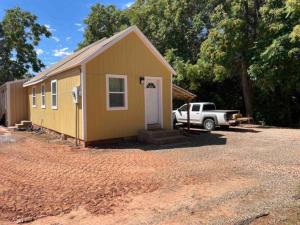 a small yellow building with a truck parked next to it at Pet-Friendly Near Zion & Hot Tub in Downtown Kanab in Kanab