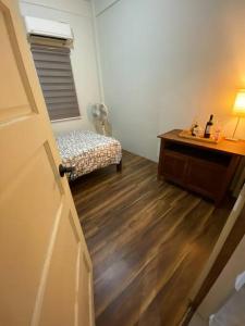 een kamer met een bed en een bureau met een ventilator bij Room near tagaytay • wifii/Netflix in Tagaytay