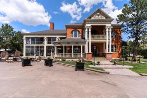 a large house with a porch on a street at Cripple Creek Hospitality House in Cripple Creek