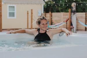 a woman in a swimming pool with a surfboard at Lake House Escape, Venture Base Unit 7 in Kanab