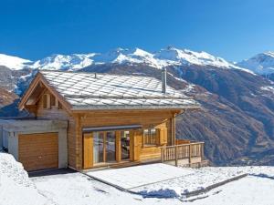 a house on top of a snow covered mountain at Chalet Falcons Nest in Hérémence