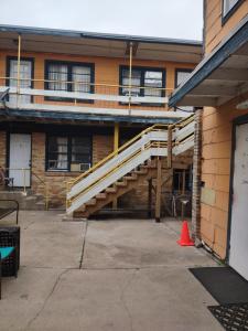 a wooden staircase in front of a building at Rosenberg Motel in Galveston