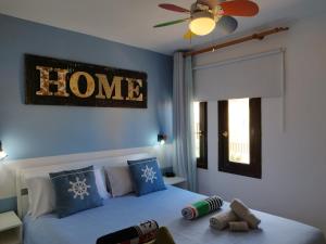 1 dormitorio con 1 cama con un cartel en la pared en Casa Del Mar - Corralejo Playa, en Corralejo