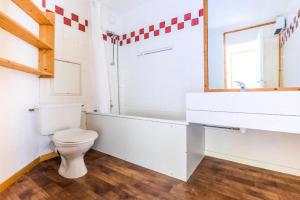 a bathroom with a toilet and a sink and a mirror at Quartier Crève Cœur - maeva Home - Duplex 3 Pièces 8 Personnes Confort MAE-3603 in Valmorel +15 photos