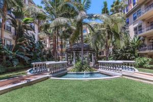 a gazebo in a yard with palm trees at Orsini Luxury Retreat: 2BR/2BA in Los Angeles