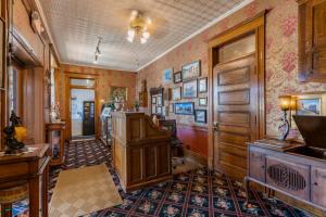 a home office with a wooden cabinet in a room at Cripple Creek Hospitality House & Travel Park in Cripple Creek