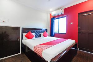 海得拉巴的住宿－Flagship Happy Guest House near LV Prasad eye Hospital，一间卧室设有一张带红色墙壁的大床