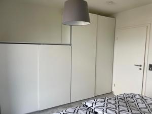 a bedroom with a bed and a large white cabinet at Ferienwohnung Lara in Bad Breisig