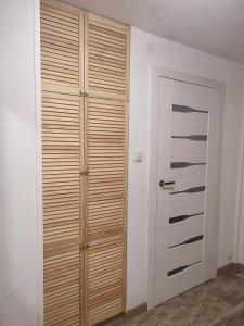 a closet with wooden doors in a room at Pod Lasem in Nowe Miasto Lubawskie