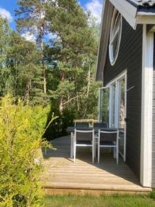 eine Terrasse mit einem Tisch und Stühlen auf einem Haus in der Unterkunft Ferienhaus für 8 Personen ca 50 m in Rockneby, Südschweden Schärengarten der Südostküste in Rockneby