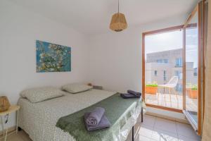 - une chambre avec un lit et une serviette dans l'établissement Le Rooftop Saint Charles parking privé, à Marseille