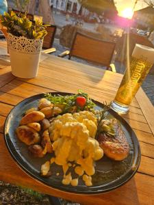 a plate of food on a table with a drink at Hotel-Restaurant Thüringer Hof in Bad Frankenhausen