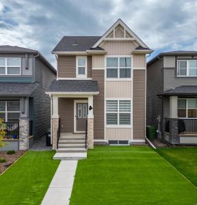 a house with a green lawn at Beautiful 3Bed-with AC-Close to Spruce Meadows & Mountains in Calgary