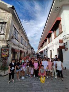 a group of people posing for a picture on a street at 15pax-U1-Rose&Fer Vigan Transient-Near Calle Crisologo in Bantay