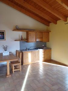 a kitchen with wooden cabinets and a table in a room at Agriturismo Trapletti in Serina +31 photos
