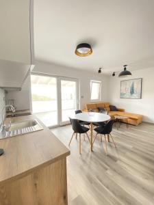 a kitchen and living room with a table and chairs at Apartments Puntica 2+1 person Rab in Rab