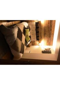 a bedroom with a bed with a lamp and a mirror at R&eacute;sidence Le Galibier 3 66910 in Les Deux Alpes