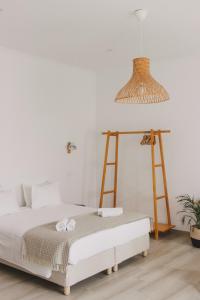a bedroom with a bed and a lamp at Pure Fonte Velha B&B in Vila do Bispo