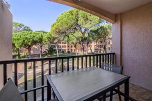 a balcony with a table and a view of a street at Résidence Saint-Raphaël Valescure - maeva Home - Studio 4 Personnes Sélection MAE-9504 in Valescure