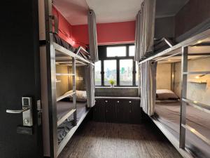 two bunk beds in a room with a window at Urban Pack in Hong Kong