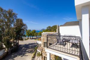 a balcony of a building with chairs on it at Asterina Hotel in Turgutreis