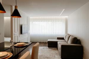 uma sala de estar com um sofá e uma mesa em A 0.4 - Alexa Smart House em Braga