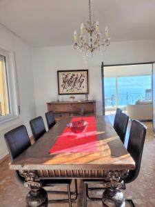 a dining room with a table with chairs and a chandelier at Villa "Genovese al Lago" in Minusio