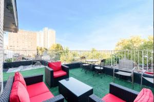 a patio with chairs and tables on a balcony at NYC Gateway! 20 Mins to Time Square, Great Value! in West New York