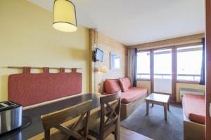 a living room with a couch and a table at Résidence L'Ours Blanc - maeva Home - Studio 5 pers Confort MAE-5828 in LʼHuez +22 photos