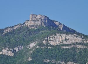 a mountain with a cross on top of it at Cosy appartement - Parking Privé Gratuit in Chambéry