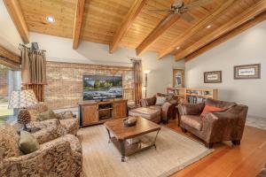 a living room with couches and a tv at Riverside Cabin home in Leavenworth