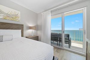 a bedroom with a bed and a view of the ocean at Crystal Shores Unit 1405 in Gulf Shores +39 photos