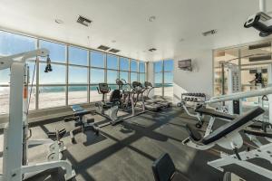 a gym with several treadmills and cardio machines at Crystal Shores Unit 1405 in Gulf Shores
