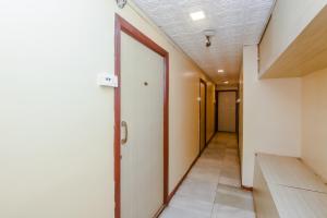an empty hallway with a door in a building at Flagship Hotel Prince Palace Near Juhu Beach in Mumbai