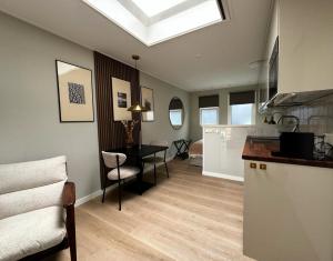 a kitchen and dining room with a skylight at Studio 43 in Hollum +6 photos