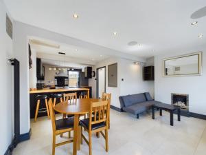 a kitchen and living room with a table and chairs at Spectacular Getaway 2BR Flat in vibrant Camberwell in London