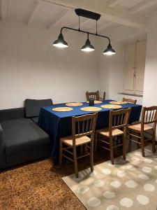 a dining room with a blue table and a couch at Lovely Tuscan Mountain Village in Sassi