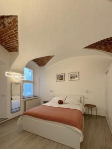 a bedroom with a bed with a teddy bear on it at Belvedere 237A Lakeview Luxury Apartment in Ghiffa