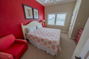 a red bedroom with a bed and a red couch at RSR2A - Endless Sunsets in Rodanthe
