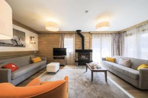 a living room with two couches and a tv at Résidence Premium L'Hévana - maeva Home - Appartement 4 pièces 8 personnes Exclusive MAE-5148 in Les Allues