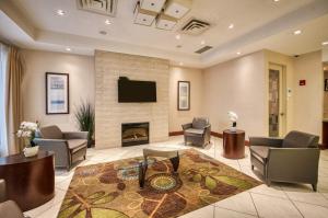 a lobby with a living room with a fireplace at Amenida Residences, Calgary in Calgary