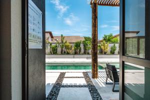 a view of a swimming pool from a house at JQY Beach Flats - 950m da Praia - Garagem subterrânea - Estação de carregamento para veículos elétricos in Juquei