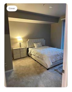 a bedroom with a king sized bed and a night stand at Entire Apartment (Los Angeles) in Los Angeles