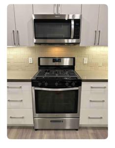 a kitchen with a stove and a microwave at Entire Apartment (Los Angeles) in Los Angeles