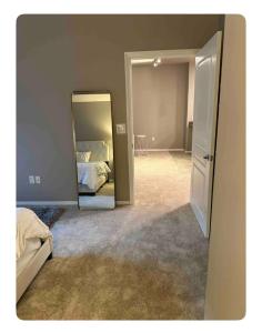 a bedroom with a mirror and a bed in it at Entire Apartment (Los Angeles) in Los Angeles