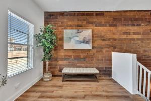 a living room with a brick wall and a bench at Bright Modern 4Bd 2Ba in the Heart of Wrigleyville condo in Chicago