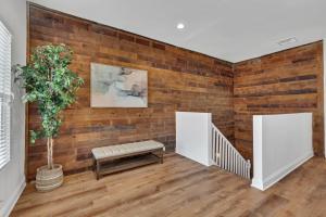 a room with a brick wall with a bench and a plant at Bright Modern 4Bd 2Ba in the Heart of Wrigleyville condo in Chicago