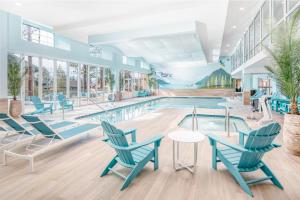 a pool with blue chairs and tables and a swimming pool at Margaritaville Resort Lake Tahoe in South Lake Tahoe