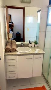 a bathroom with a sink and a mirror at RAVENA 11 in Ribeirão Preto