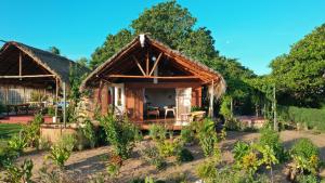 a small house in the middle of a forest at Piecefull bayview Cottage with Kitchen near Tofo in Inhambane